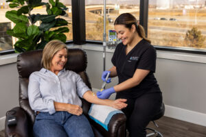 Nurse placing IV into a patient's arm for infusion